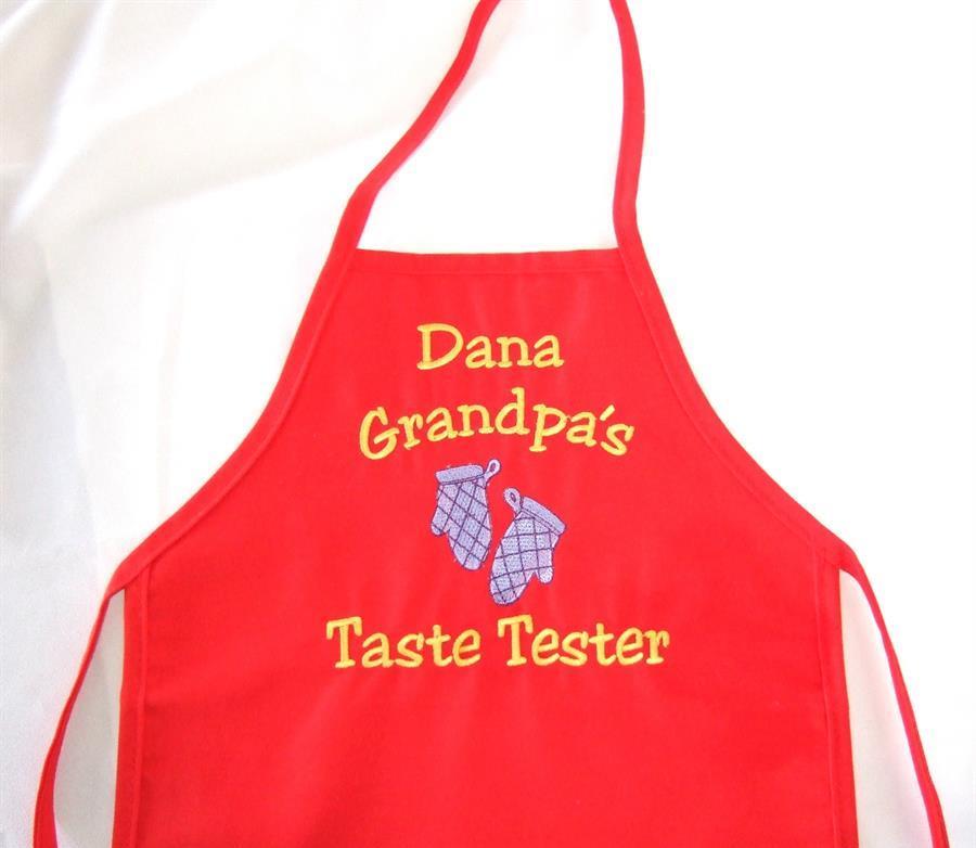 Child's red apron with custom saying.