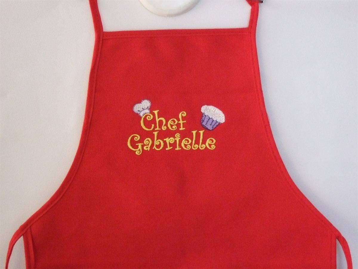 Child's red apron with chef hat and cupcake 