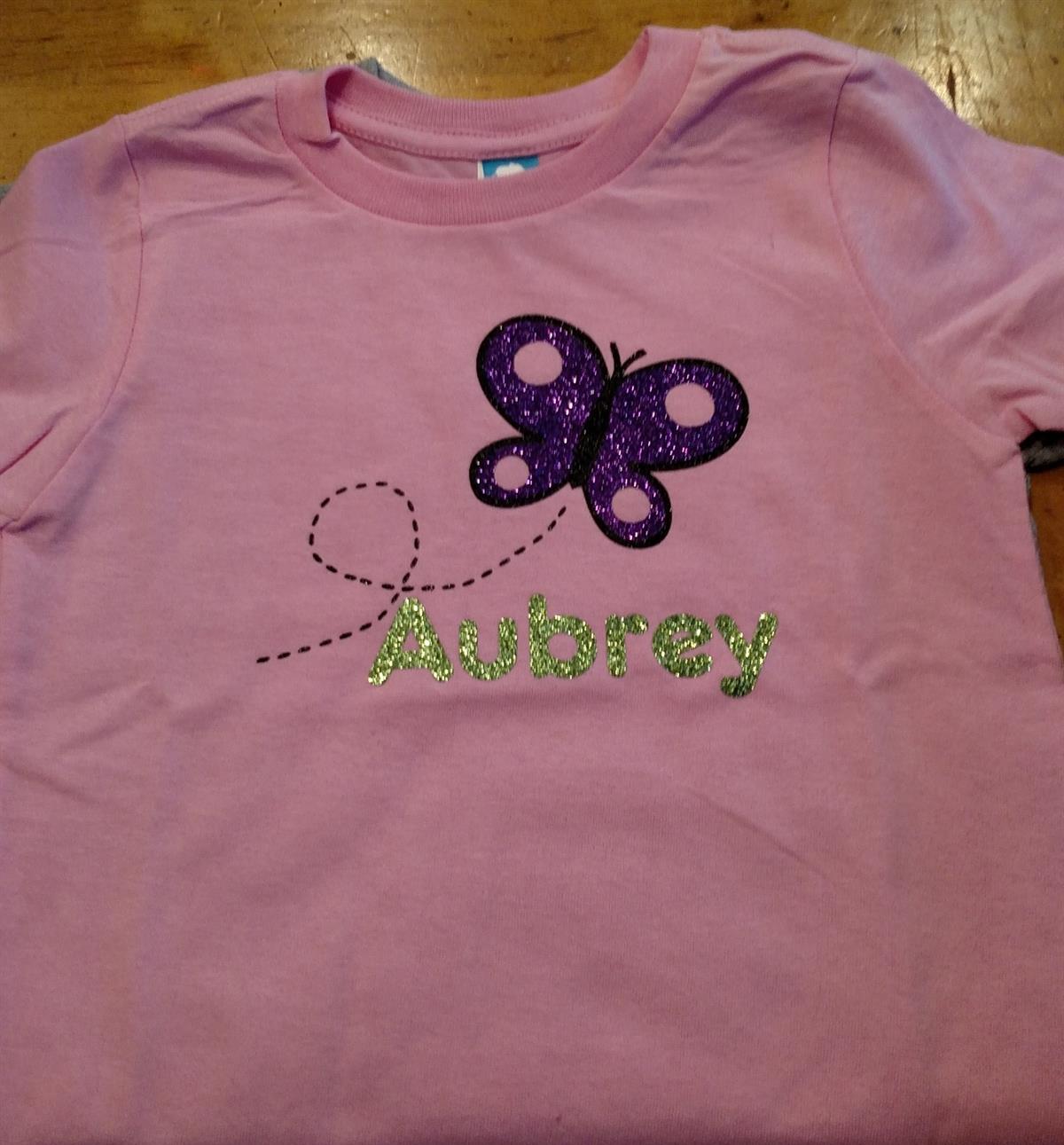 Pink custom youth tee with glitter name & butterfly